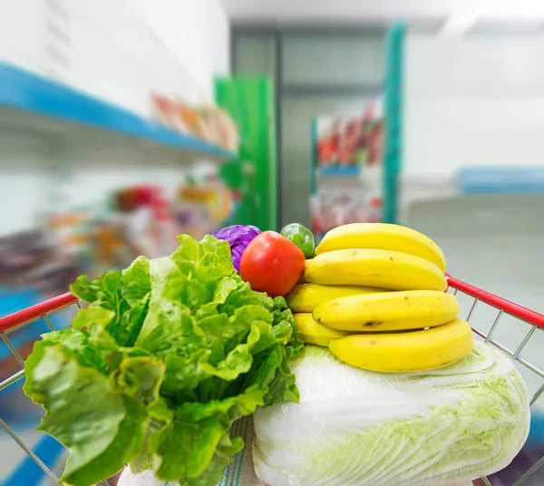 Winkelwagen met groenten en fruit — Stockfoto