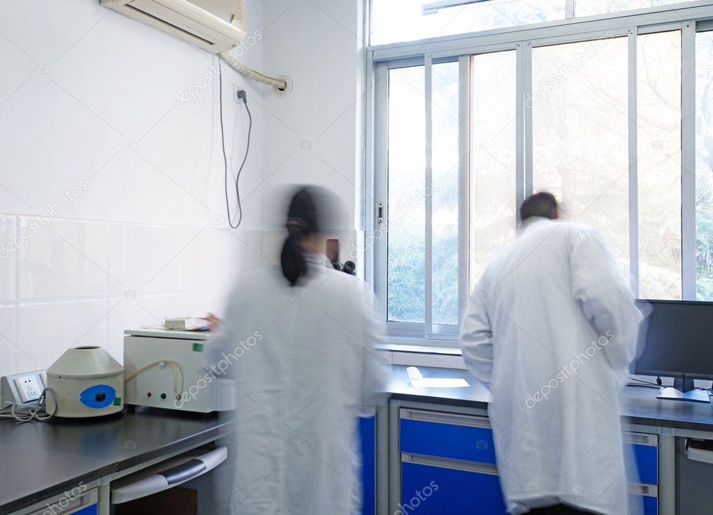 Researchers working in chemistry laboratory