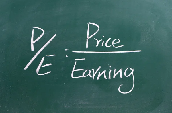 Price per earning ratio written on blackboard — Stock Photo, Image