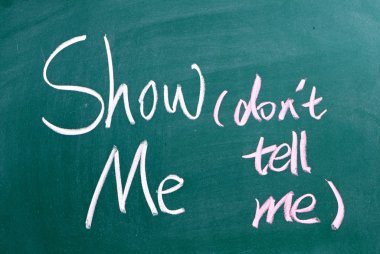Show Me, Don't Tell Me written by hand on a used blackboard clipart