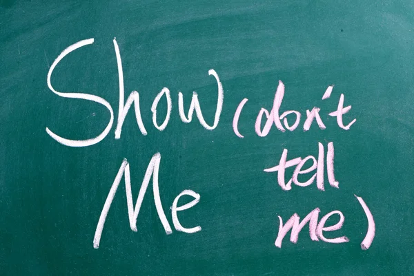 Show Me, Don't Tell Me written by hand on a used blackboard — Stock Photo, Image