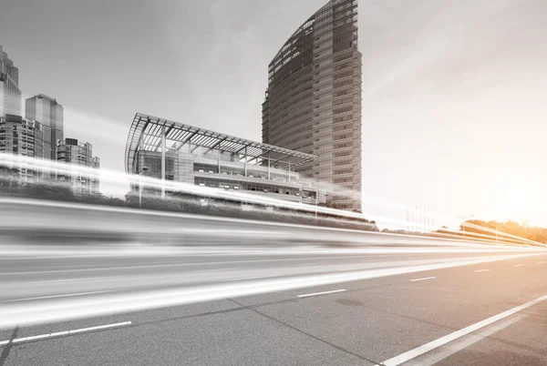 Light trails on buildings background — Stock Photo, Image