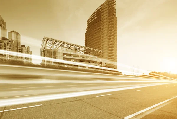 Light trails on buildings background — Stock Photo, Image