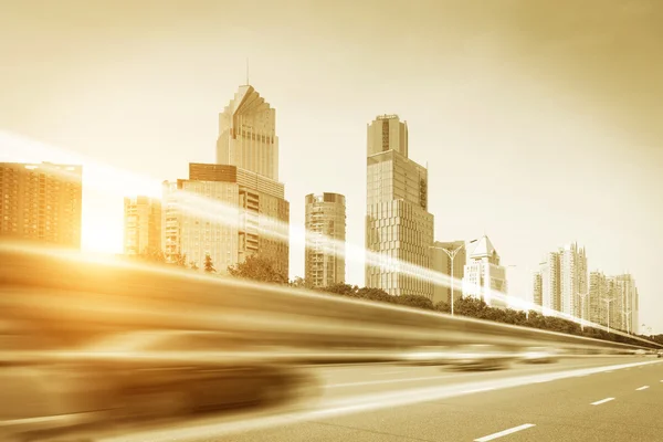 Light trails on buildings background — Stock Photo, Image