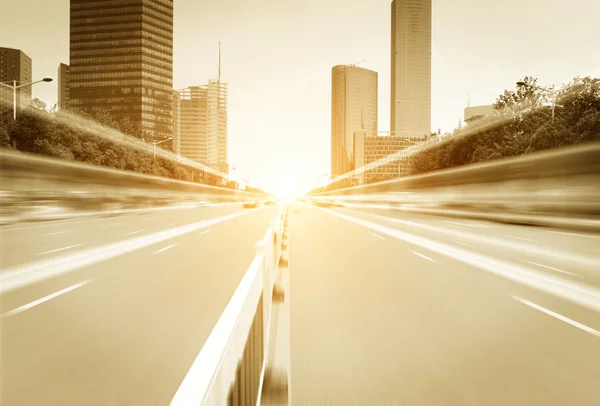 Light trails on buildings background — Stock Photo, Image