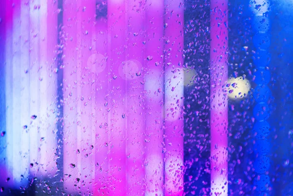 Wet window with night city — Stock Photo, Image