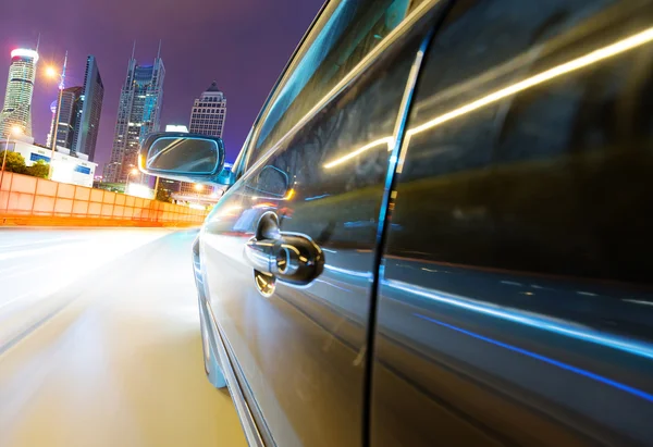 Speeding car go through the city — Stock Photo, Image