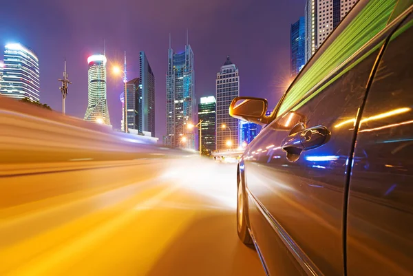 Speeding car go through the city — Stock Photo, Image