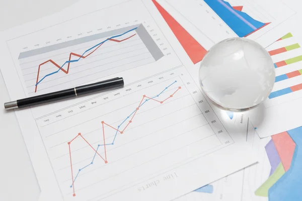 Globe and chart on desk — Stock Photo, Image