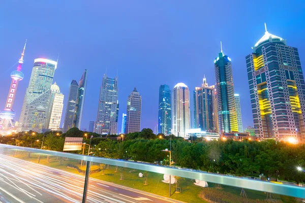 Light trails on buildings background — Stock Photo, Image