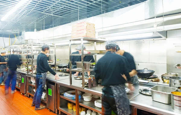 Motion chefs of a restaurant kitchen — Stock Photo, Image