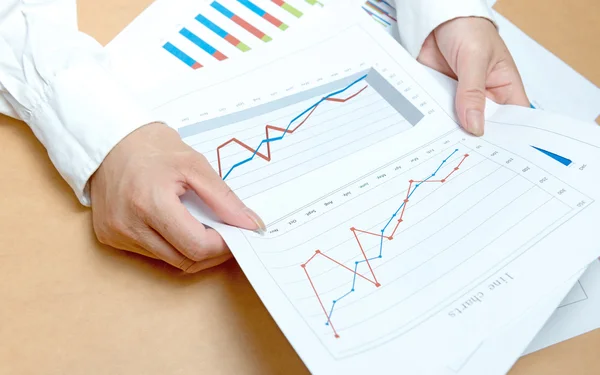 Woman hands with charts and papers — Stock Photo, Image