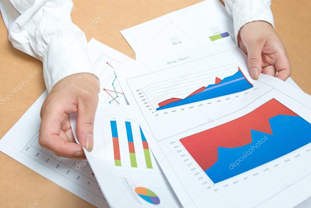 woman hands with charts and papers
