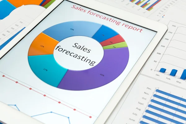 Financial charts on the table with tablet — Stock Photo, Image