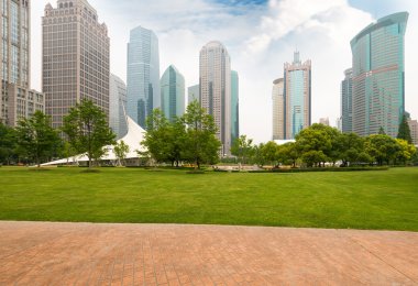 city park with modern building background in shanghai clipart