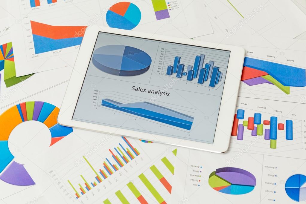 Financial charts on the table with tablet