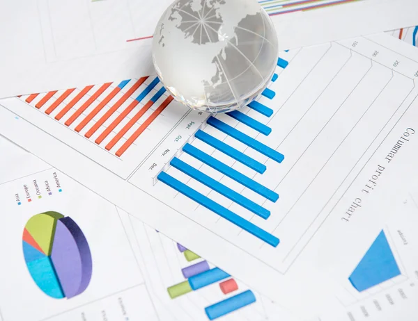 Globe and chart on the desk — Stock Photo, Image