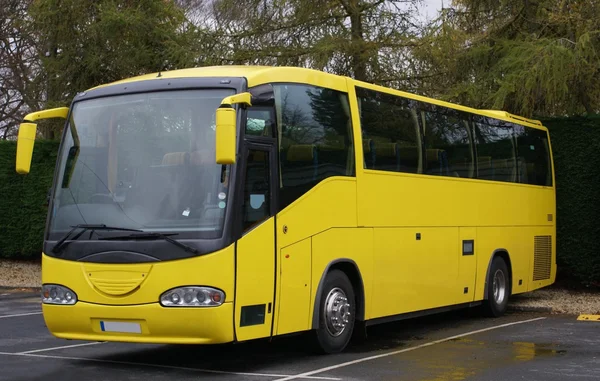 Yellow bus or coach in a car park — Stock Photo, Image
