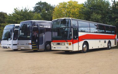 Buses or coaches parked in a car park clipart