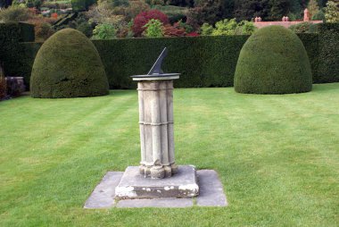 Sundial & topiary. Powish castle garden, Welshpool, Powys, Wales, England clipart