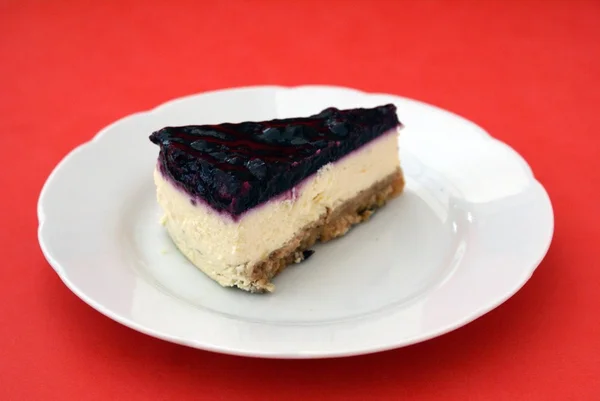 Piece of blueberry cheesecake on a plate. dessert — Stock Photo, Image