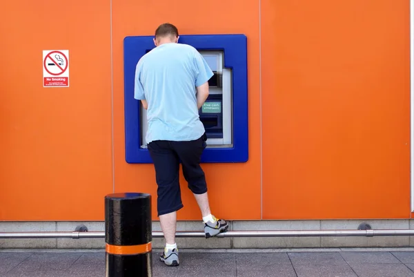 Man using ATM or a cash machine — Stock Photo, Image