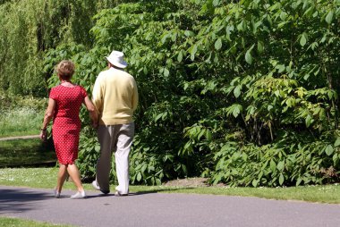 Bir parkta elinde el yürüme Çift