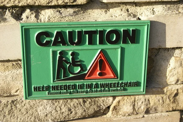 Caution sign. Caution for a wheelchair people. Caution for disabled people. — Stock Photo, Image