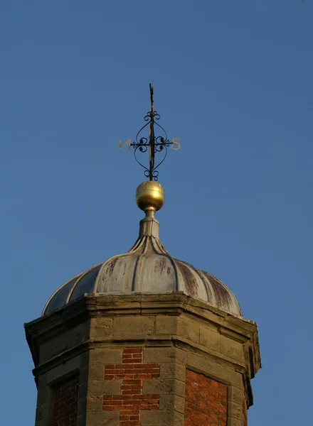 Domed tower with golden ball & ornamental weather vane — Zdjęcie stockowe