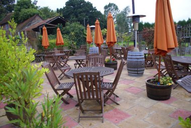 wooden chairs and tables in a patio