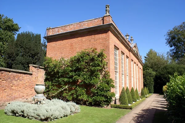 Sculptured old architecture and yew topiary trees — Stock Photo, Image