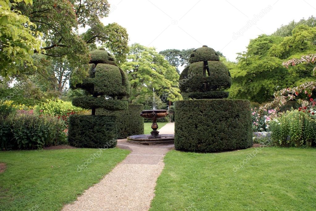 garden with fountain and topiary trees
