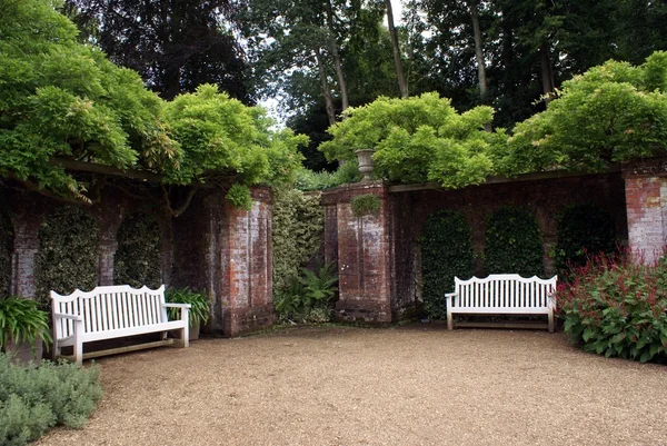 Wooden benches in a garden — Stock Photo, Image