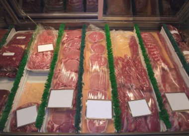 Display of meat in a fridge of a butcher shop, store, or market clipart