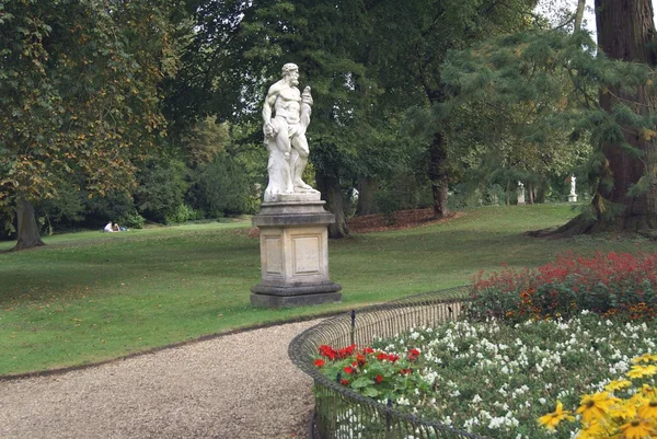 Сад с мужской статуей — стоковое фото