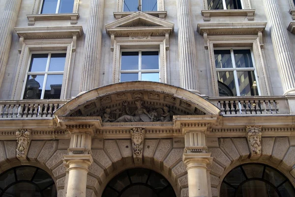 Ornate facade with a pediment, sculptures, and columns — Stock Photo, Image