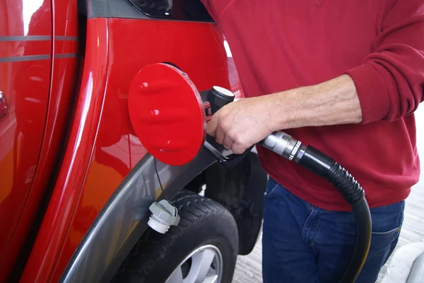 Repostaje de coches. mano de un hombre rellenando un coche con gasolina en una gasolinera — Foto de Stock