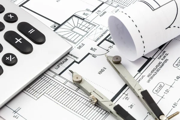 Architectural drawings of a house with compass and calculator — Stock Photo, Image