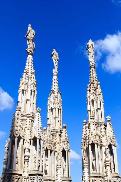 Estatuas sobre la Catedral de Milán y el cielo azul — Foto de Stock