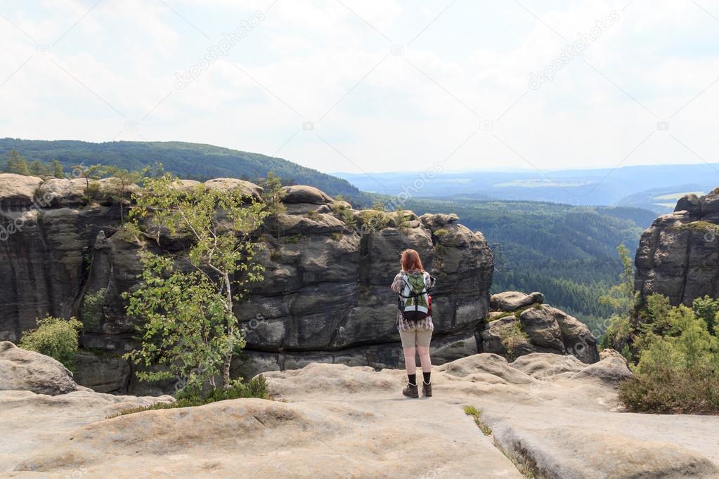 Female hiker looking at panorama from Affensteine in Saxon Switzerland