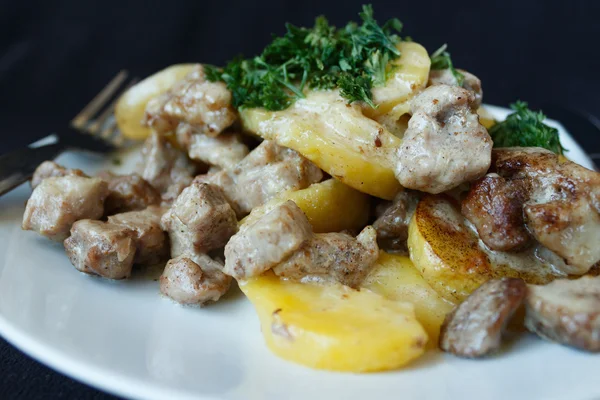 Baked potatoes, pork with cream — Stock Photo, Image