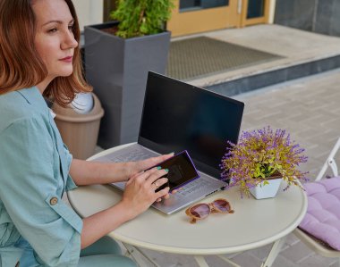 Kafede bilgisayar başında çalışan ciddi bir kız.