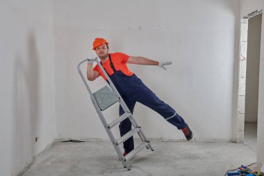 Parlak şapkalı bir tamirci tamir eder.