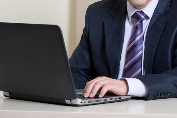 Businessman using laptop in office — Stock Photo, Image