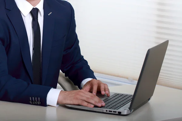 Businessman using laptop in office — Stock Photo, Image