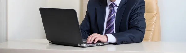 Businessman using laptop in office — Stock Photo, Image