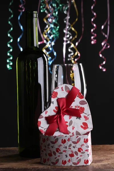 St Valentine 's setting with present and red wine — стоковое фото