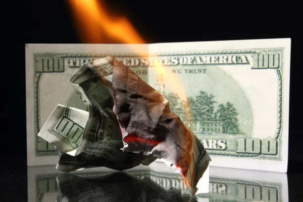 Dollars in fire, burning dollar, ashes. Crisis