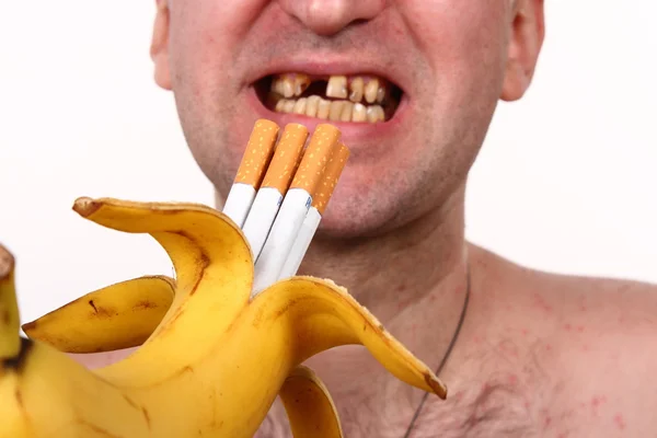 Cigarettes in a banana, smoker, bad teeth — Stock Photo, Image