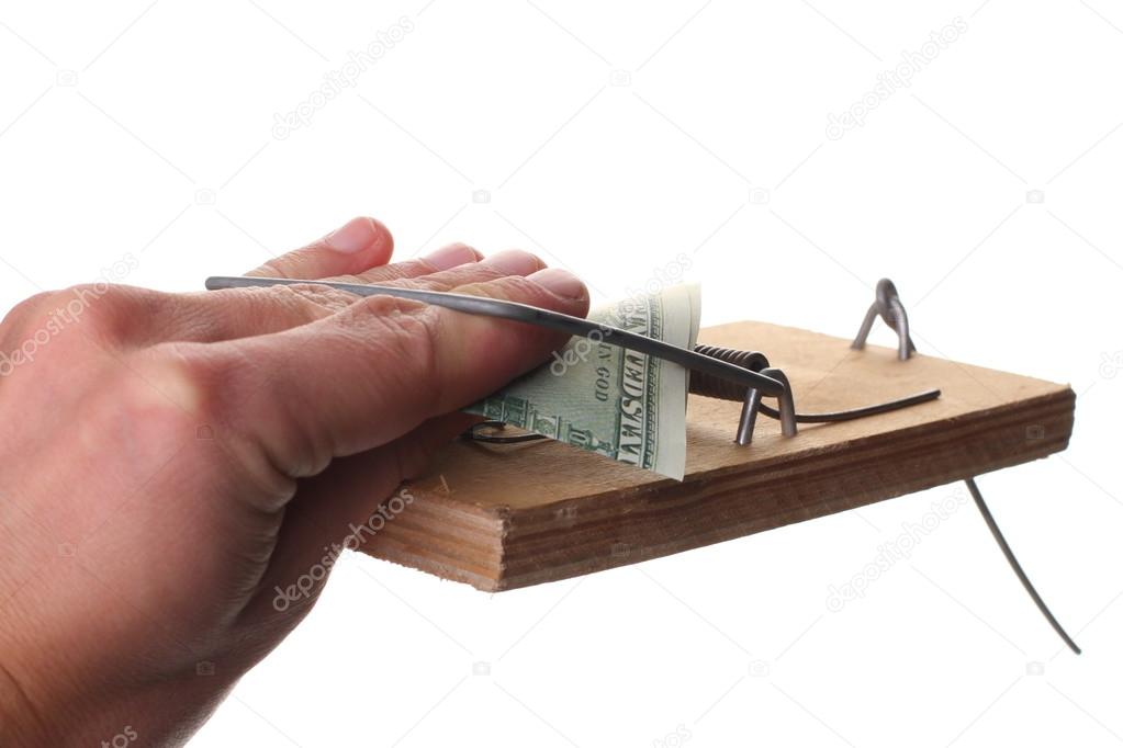 Trap with dollar bills isolated over white background, Risk in business, Businessman taking money from a mousetrap.
